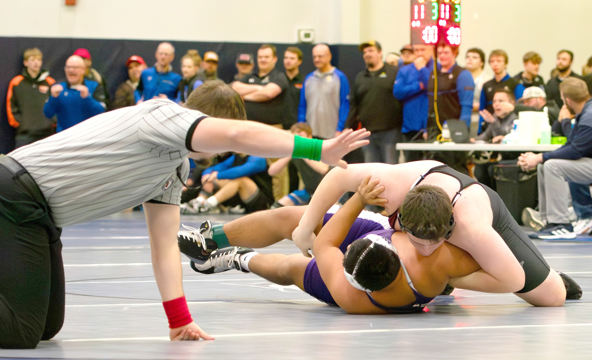 Isaac Carey goes for a pin on Friday. The freshman finished fourth at 285 pounds. NCJ photo by Melissa Aaberg