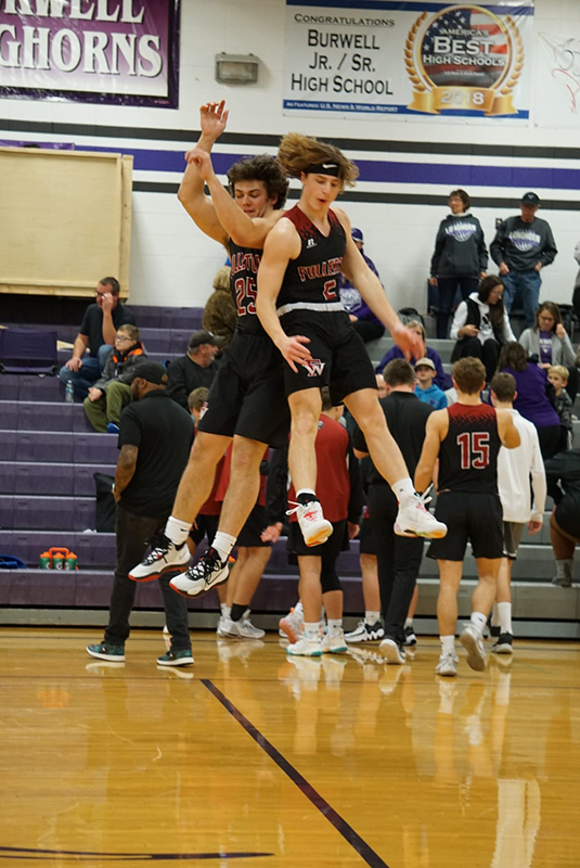 Seniors Jaxson Sullivan and Brady Cook jump to get the team fired up before the game. Photo by Laura Sabata