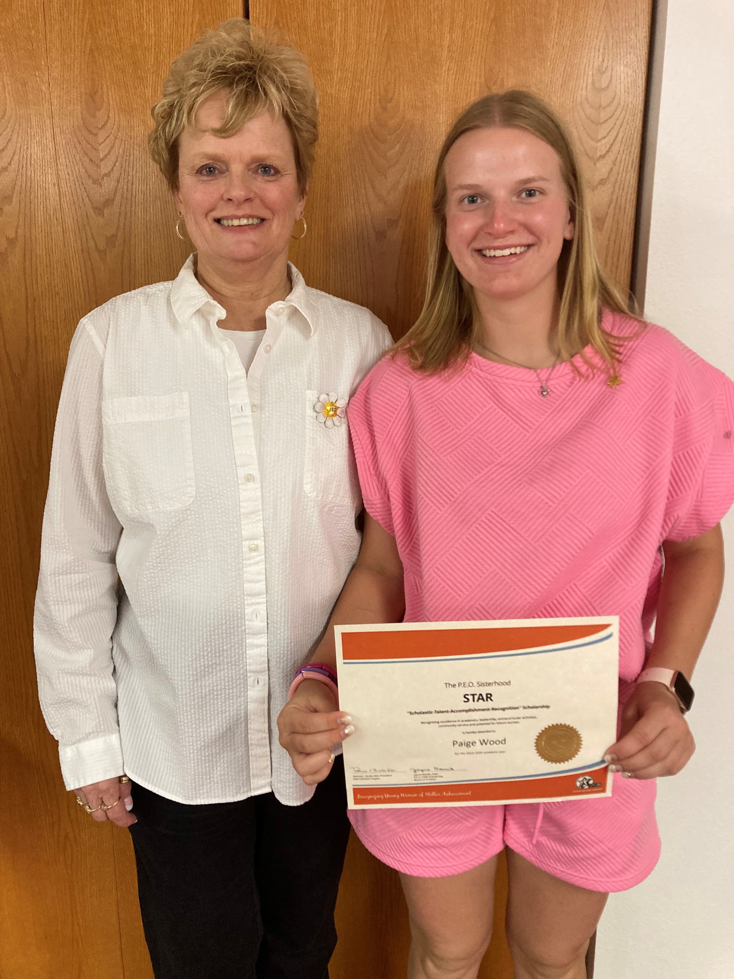 Cindy Russell, Chapter AG President awards Paige Wood a certificate that recognizes her receipt of the P.E.O. Star Scholarship. Photo provided