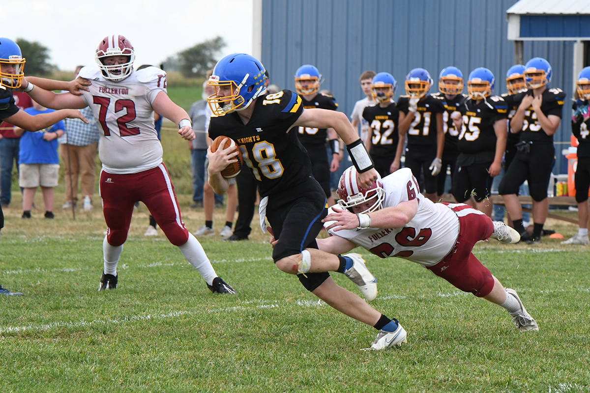 Aidan Bittner makes a diving grab for Nebraska Lutheran quarterback Isaac Beiermann. Bittner finished with 2 tackles in the game. NCJ photo by Rick Holtz