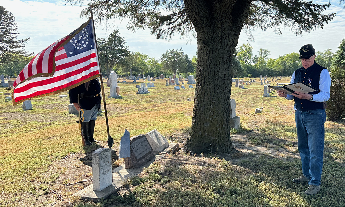 Norm Webber leads the ceremony to mark the grave of the last Union Civil War soldier buried in Nance County. Charles H. Adams died Aug. 23, 1940 and he is buried in the Fullerton Cemetery. NCJ photo by Rick Holtz