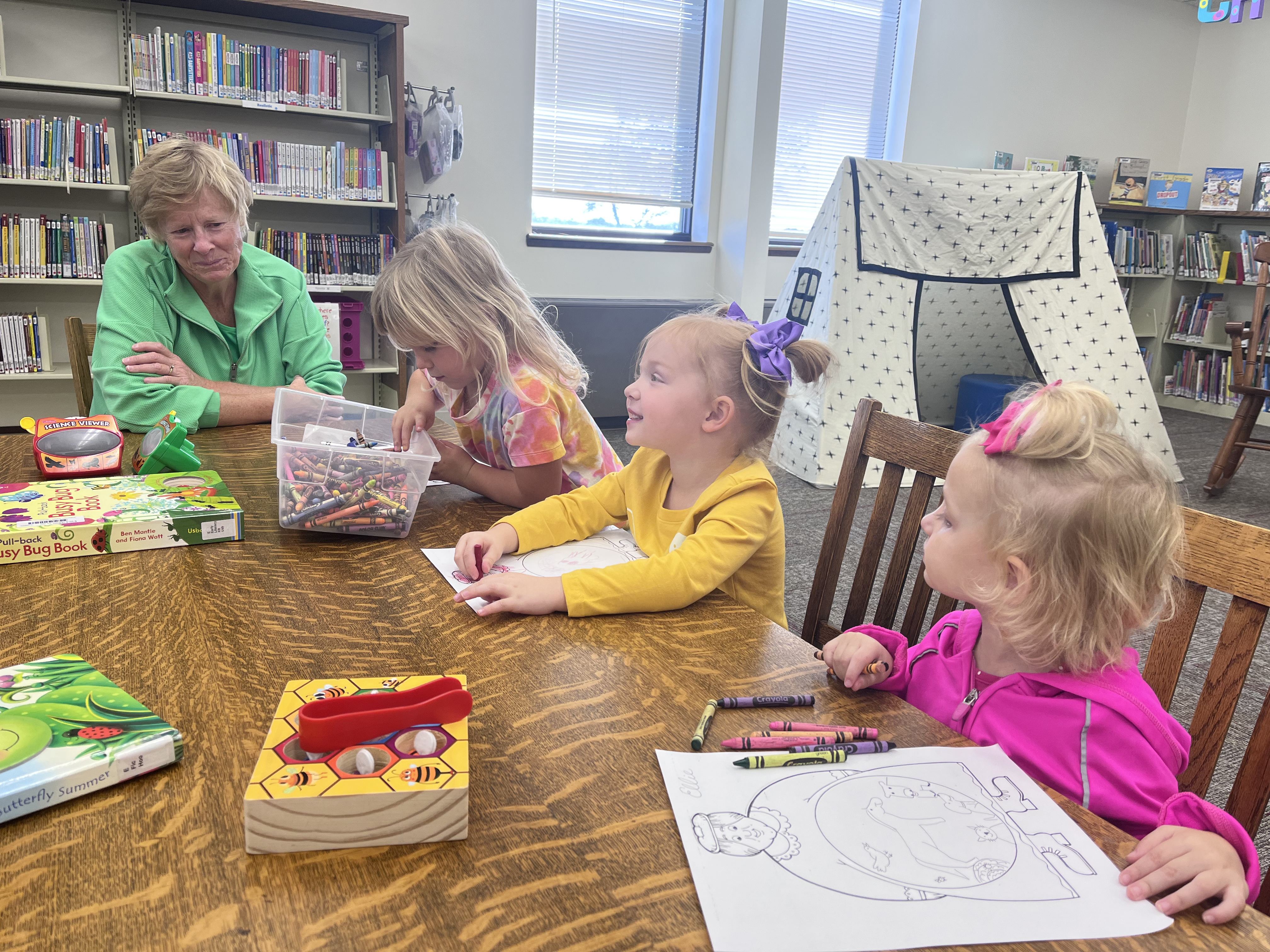 Mary Pat Nathan (left), Blair Boryca, Harlow Wetovick and Ellie Carr work on a craft at the Fullerton Library. NCJ photos by April Carr