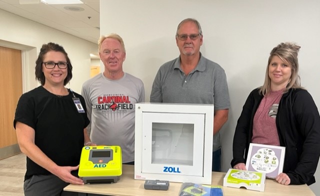 Amy Olnes, APRN, FNP-C presents AED to church council members Tom Dickey, Chris Nelson and Sara Rasmussen. Photo provided