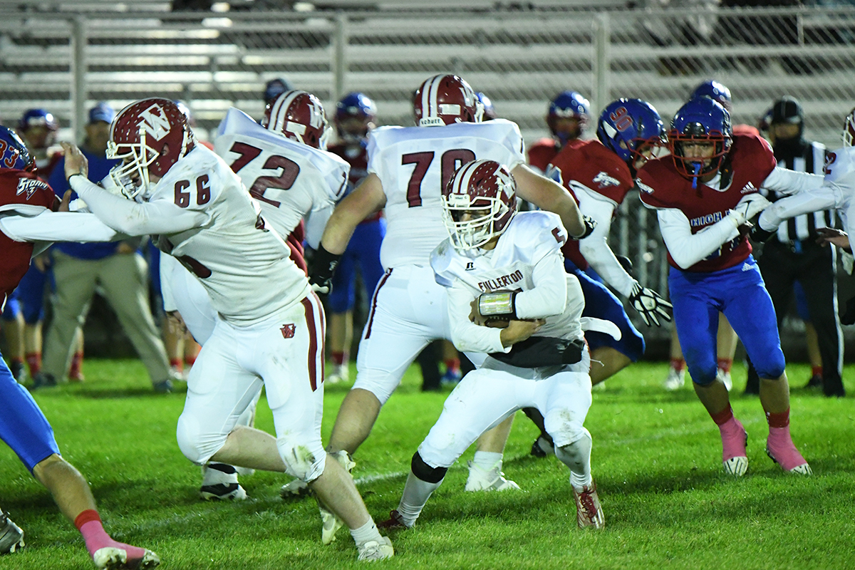 Fletcher Dubas runs the ball in Fullerton's final game of the regular season. The Warriors open the playoffs on Thursday at Humphrey when they take on St. Francis. NCJ photo by Rick Holtz