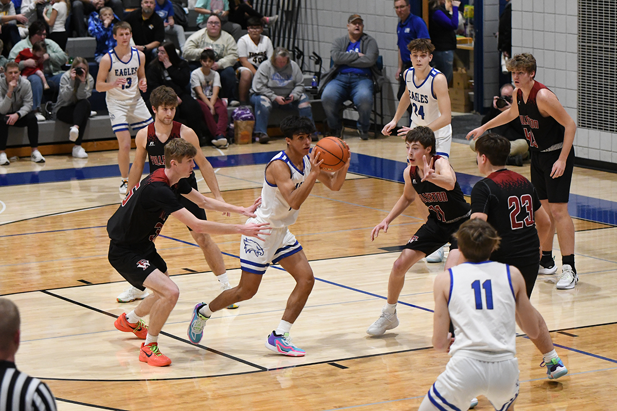 The Warrior defense collapses on the ball handler last week when Fullerton played Lutheran-Northeast. NCJ photo by Rick Holtz
