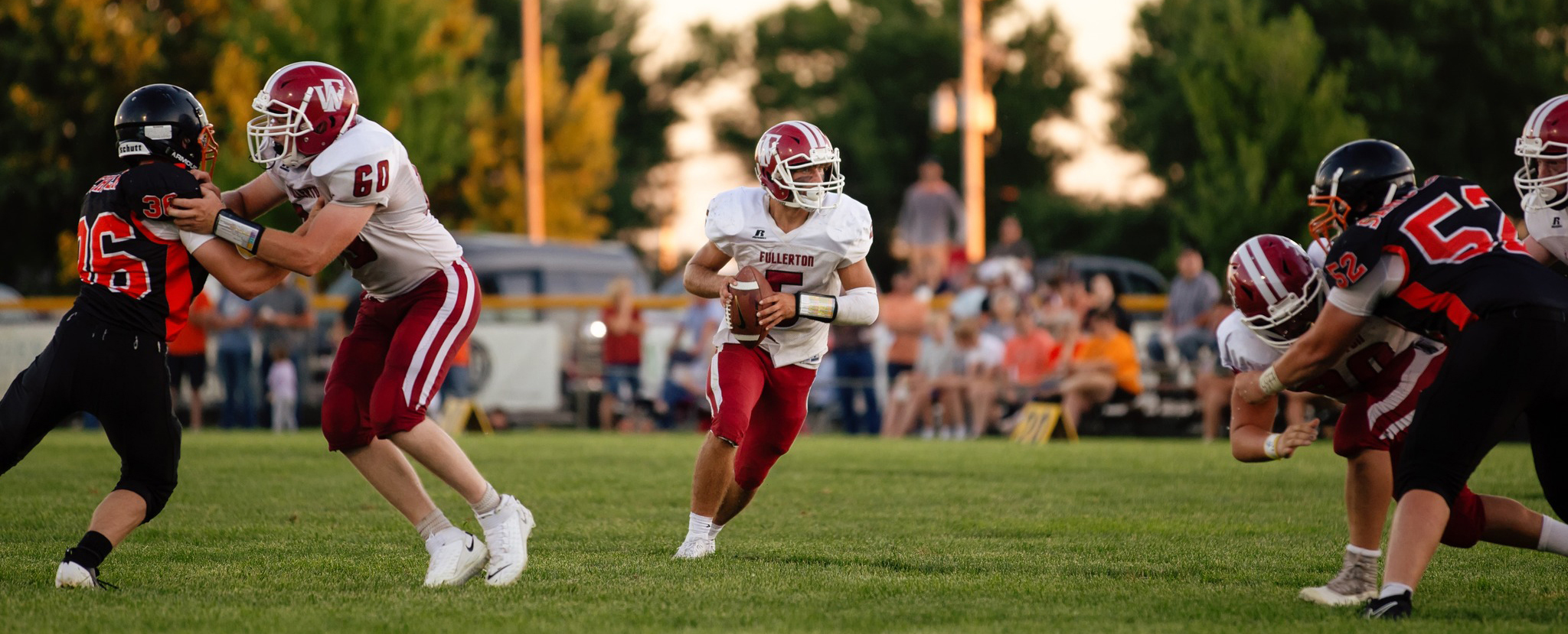 Fletcher Dubas looks down field for the open receiver against Palmer. The senior quarterback connected with five different receivers on Friday. NCJ photo by Whitney Busch