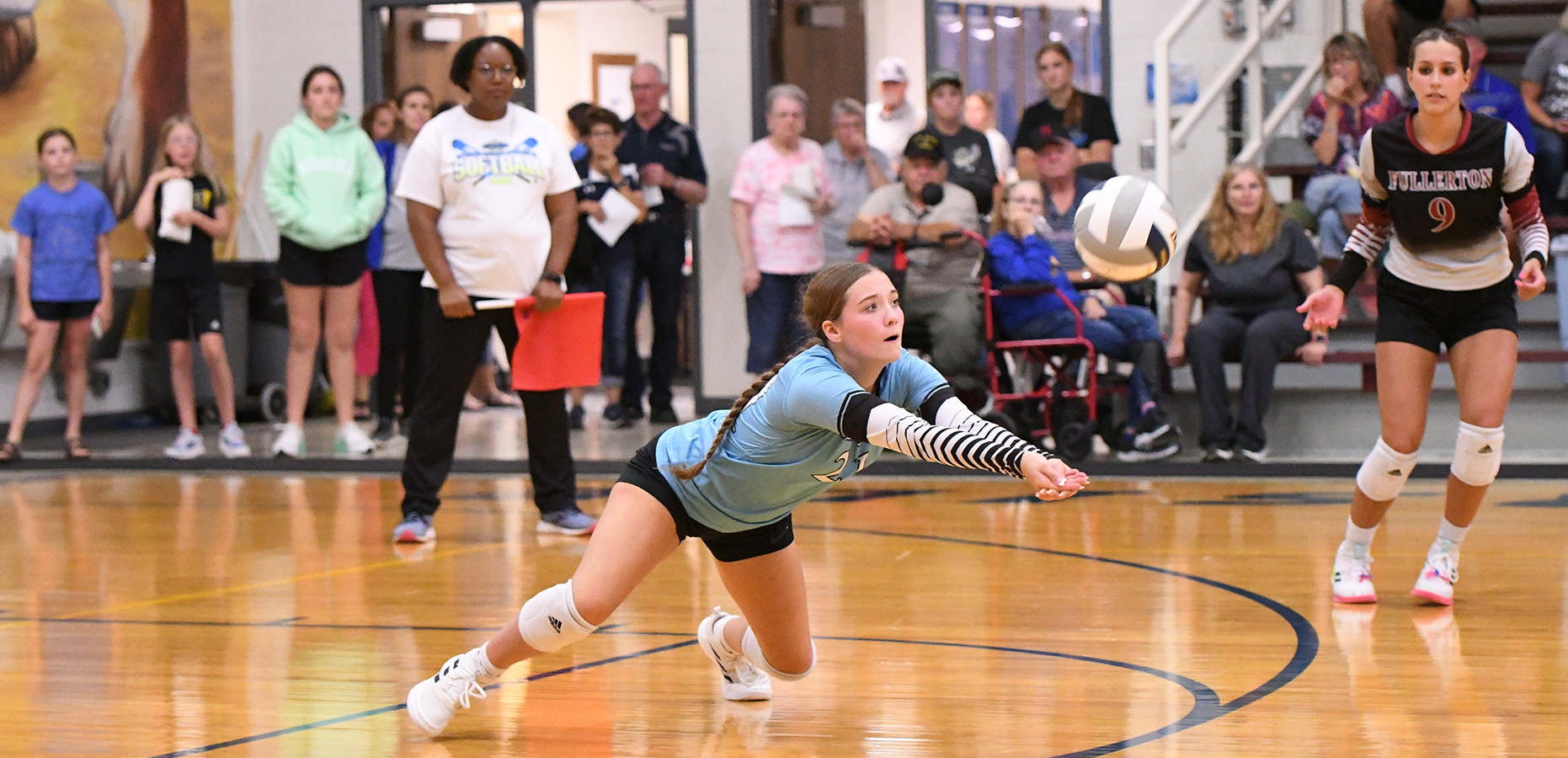 Tylar Konwinski makes a diving save against Riverside. She had 7 digs against the Chargers. NCJ photos by Rick Holtz