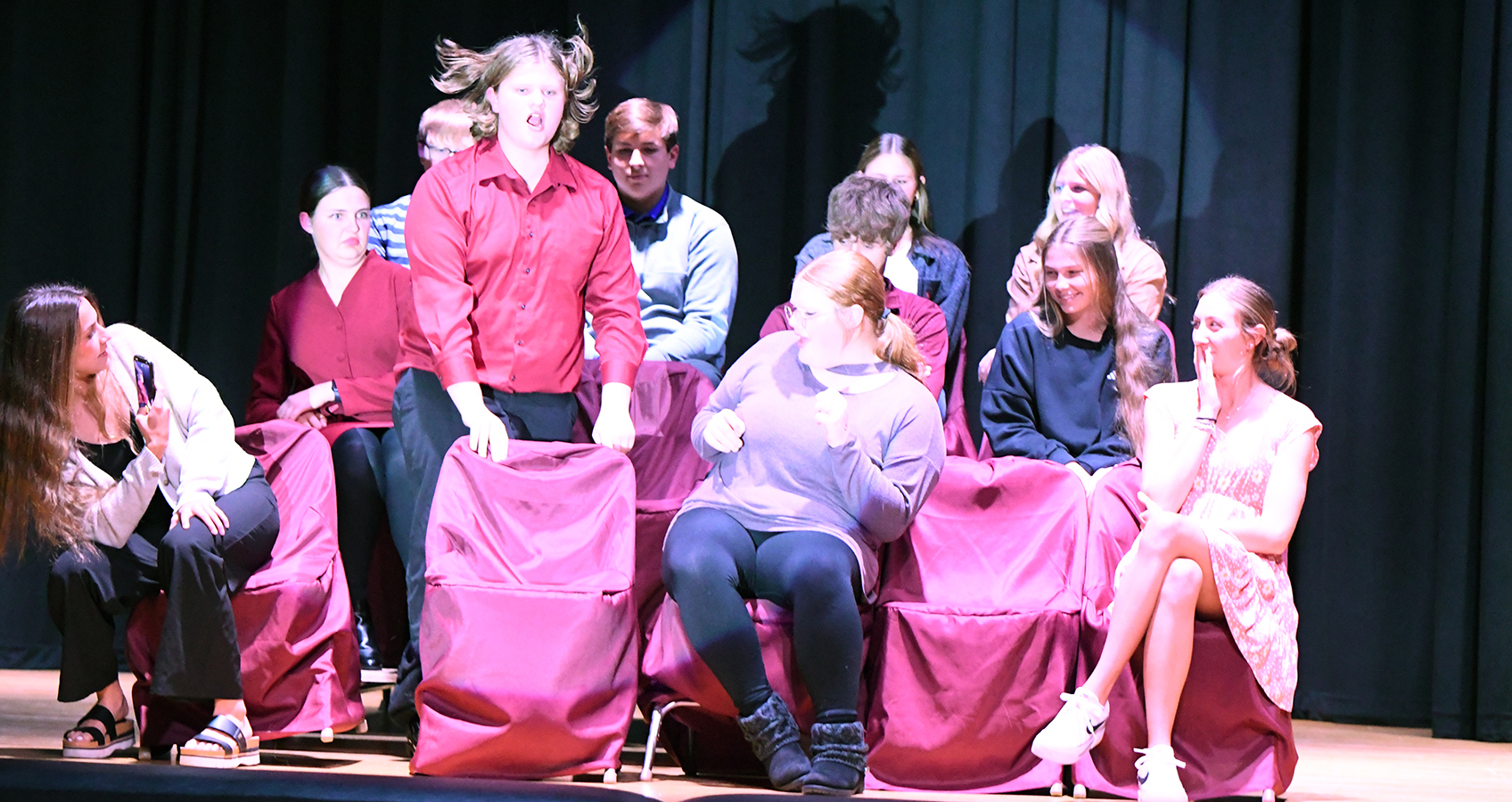 Augden (played by Colton Harris) has a little trouble getting comfortable in his chair after trading seats with Ashley (played by Kinzie Sharman) in Fullerton’s play production “Appropriate Audience Behavior.” The community is invited to a performance on Friday, Nov. 15 in the school gymnasium. NCJ photos by Rick Holtz