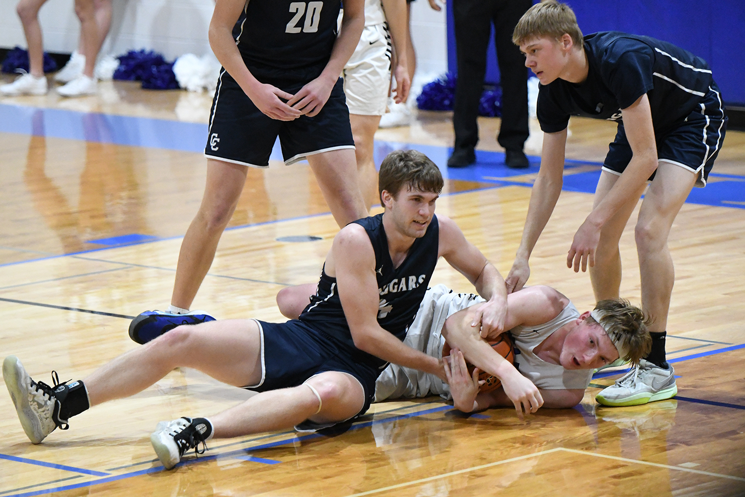 Lane Lund puts his body on the line for a loose ball against Cross County. NCJ photo by Rick Holtz