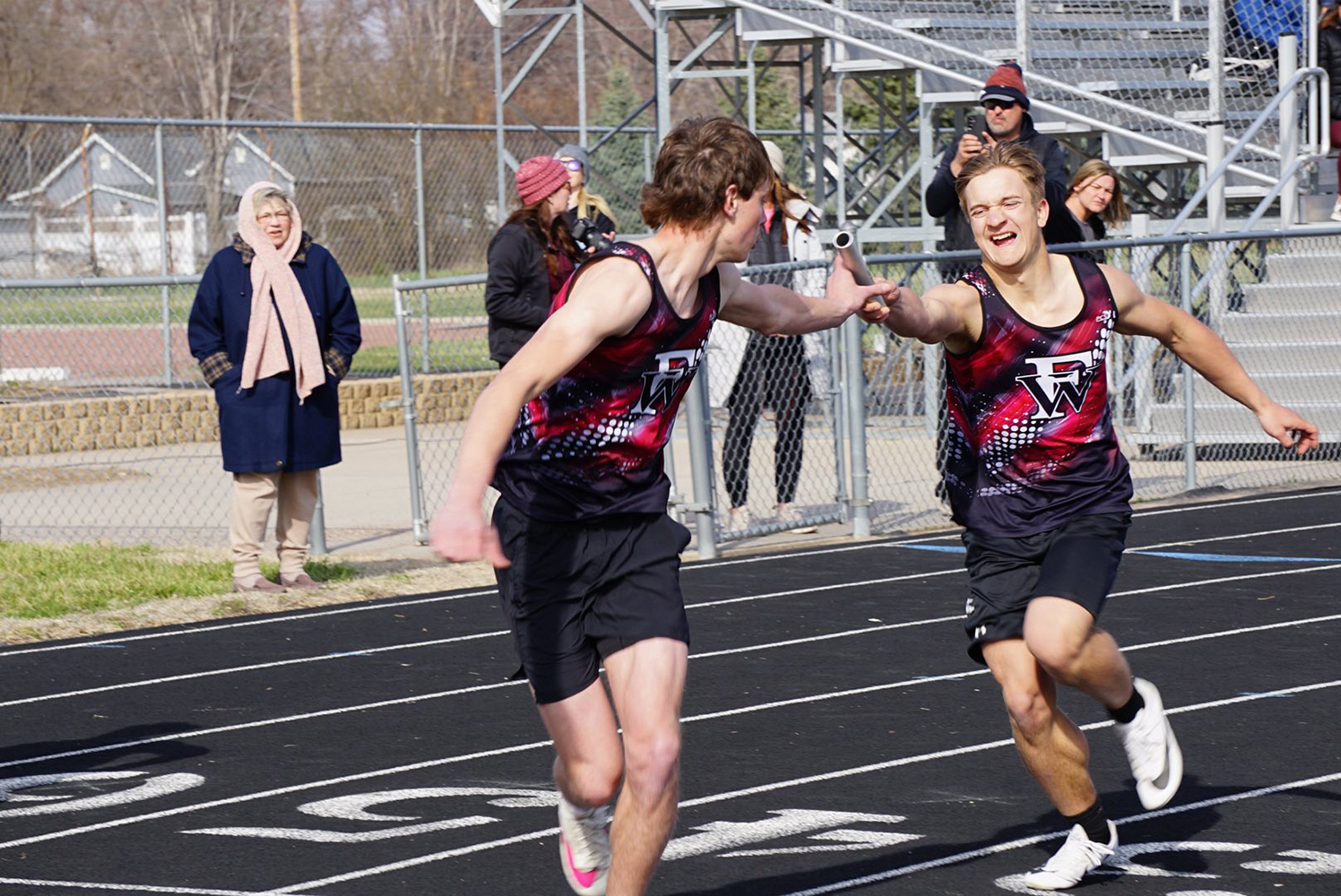 Cael Dubas makes the exchange with Nolan Dubas in the 4x100-meter relay at Burwell. NCJ photo by Cathy Cook