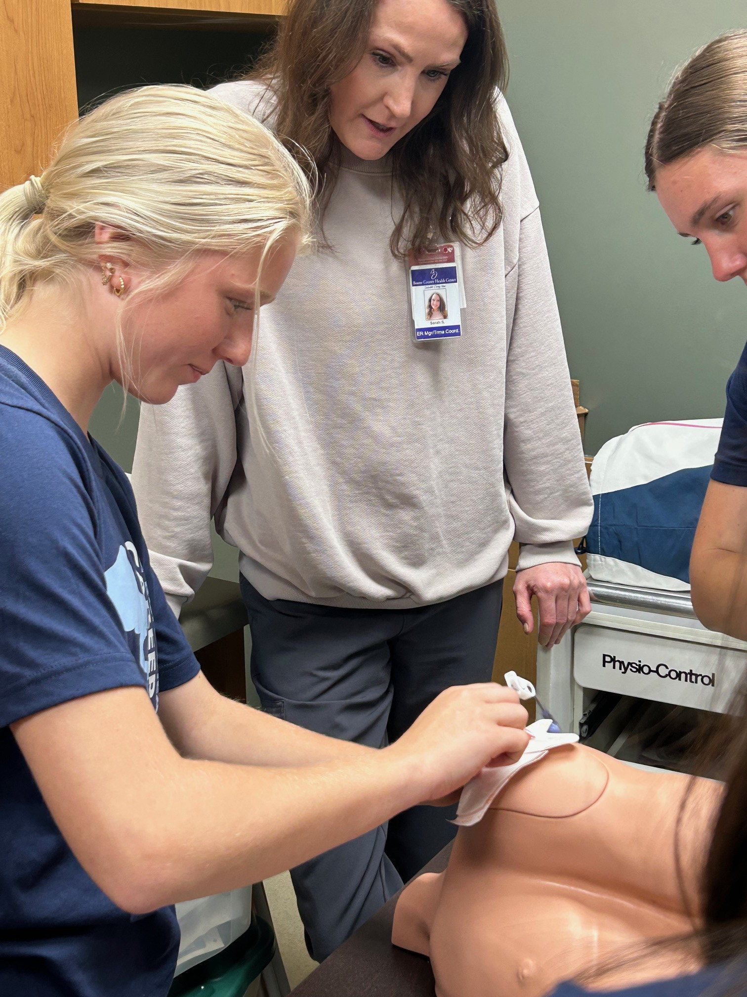 Brooke Kinney practices inserting an intraosseous (IO) needle into a shoulder model to establish emergency access for fluid administration. Photo provided