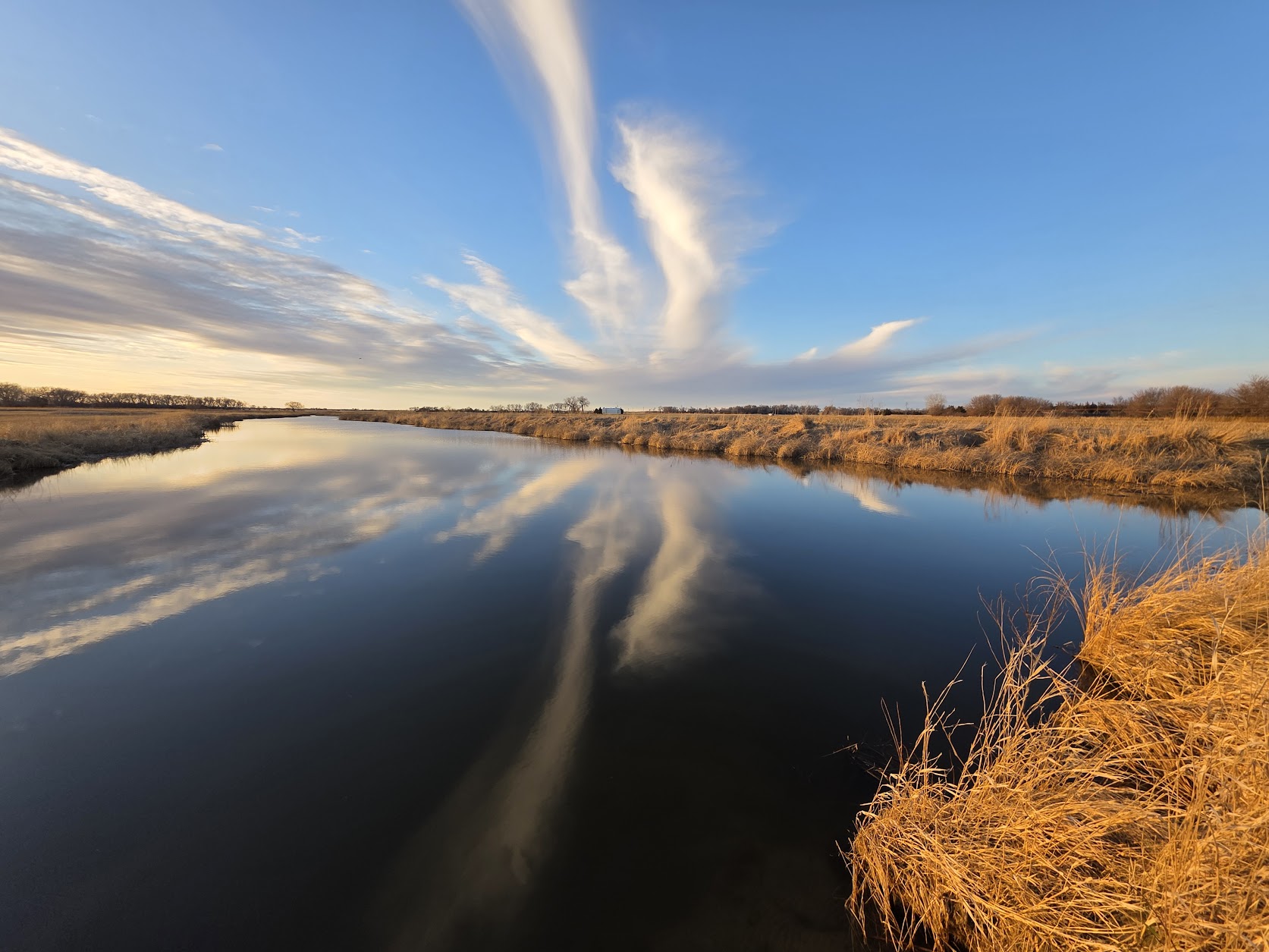 Lawrence Burman of Rockville won first place for his image of a deep blue, cloud-streaked sky reflected in the tranquil waters of a Middle Loup River slough in Sherman County.