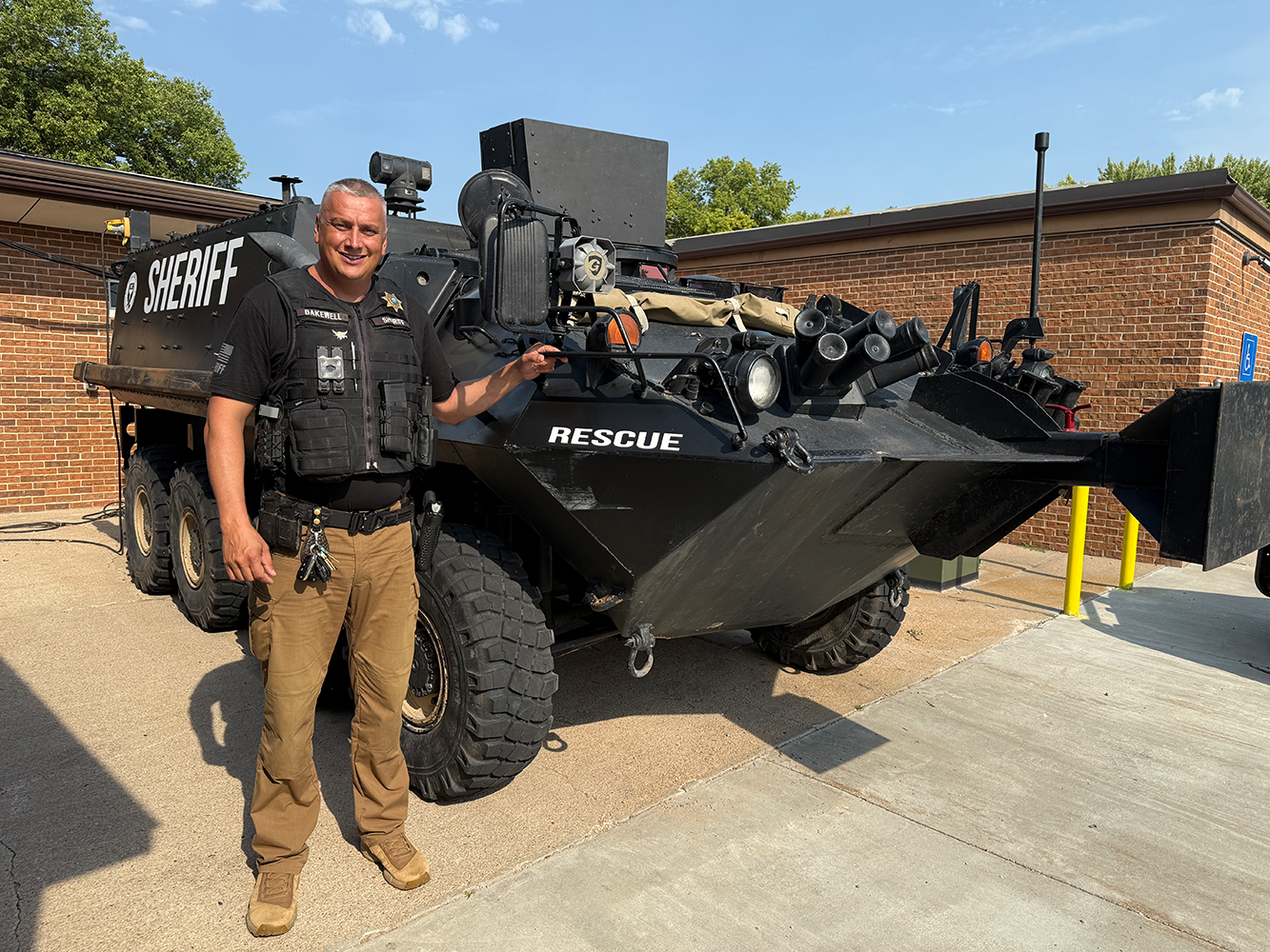 Nance County Sheriff Ben Bakewell stands next to the Special Response Team’s new armored vehicle. The team can use the 12.8 ton, 8-wheeled Stryker to execute high-risk search warrants or a water rescue. NCJ photo by Rick Holtz