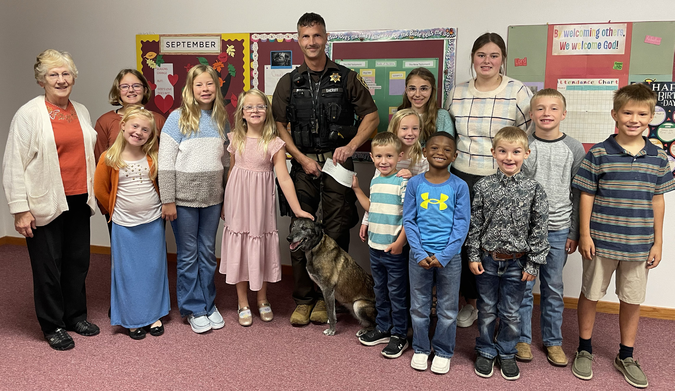 Fullerton Community Church Sunday School class poses with Deputy Woollen and Zina Photo provided
