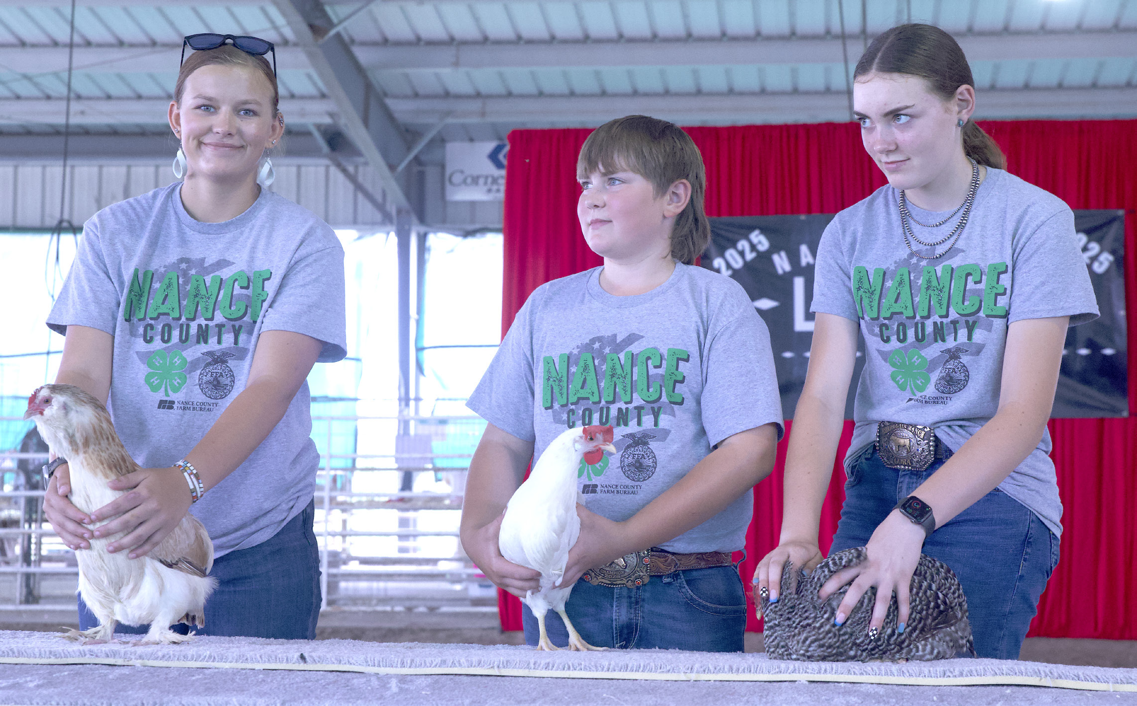 Delylla Olson, Luke Sonderup and Lora Sonderup show their exhibits during the Poultry Show on Friday.