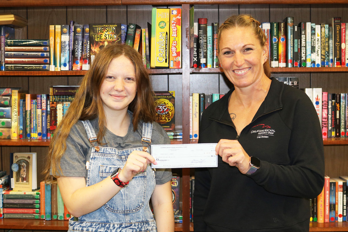 Cornhusker Public Power Trustee Abie Czapla (right) presents $200 to the Genoa Public Library for the teen LEGO club program. Accepting the check is President of the Advisory Group Jocelyn Robertson (left). Photo provided