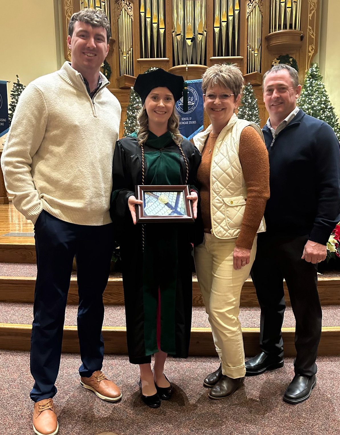 Dr. Kramer with her husband Kyle and parents John and Tracy Beckman following her Early Career Alumni Award recognition. Photo provided