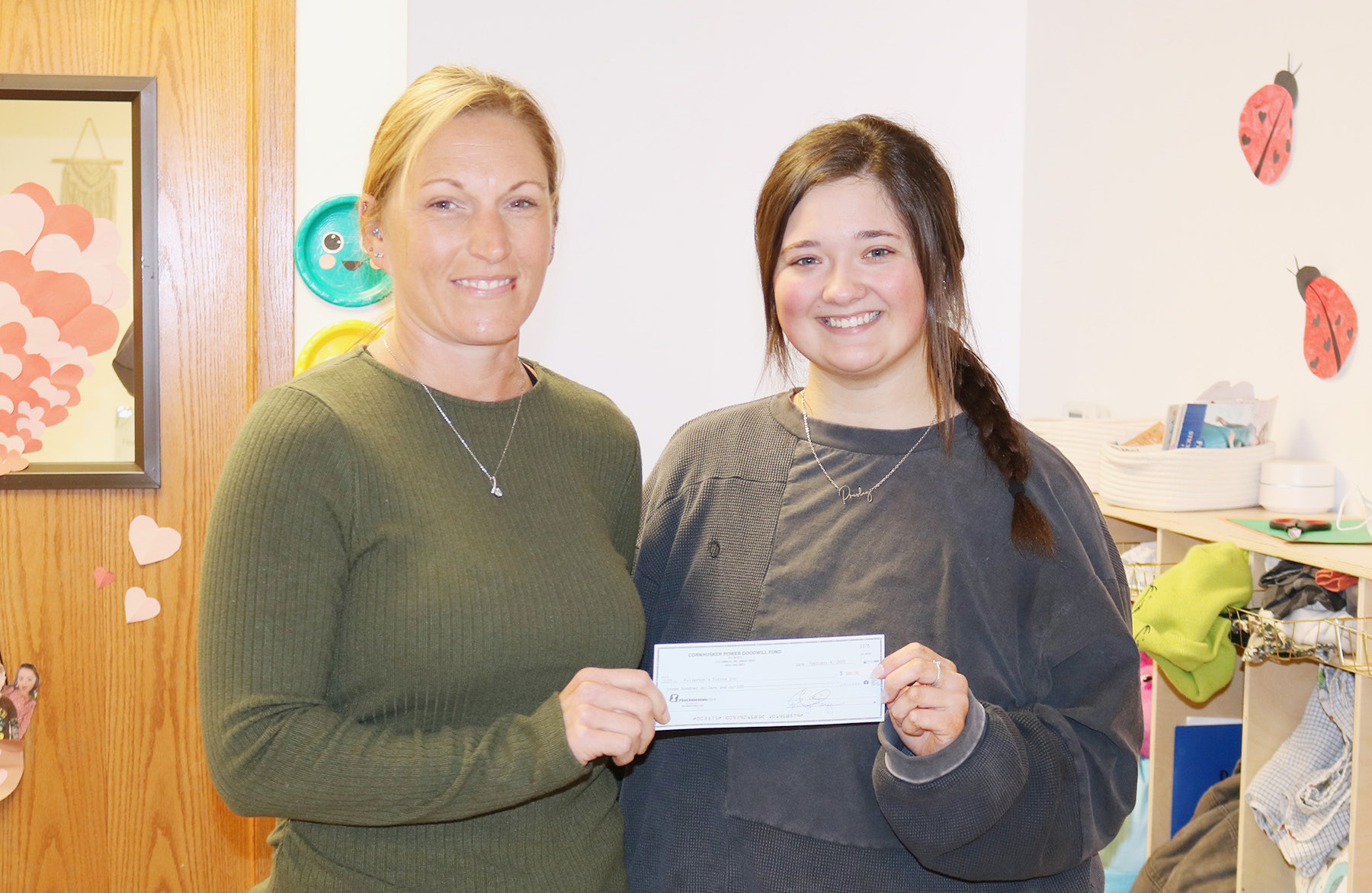 Cornhusker Public Power Trustee Abie Czapla (left) presents $300 to Fullerton’s Future Inc. for playground equipment. Accepting the check is Infant Lead Teacher Riley Buck. Photos provided