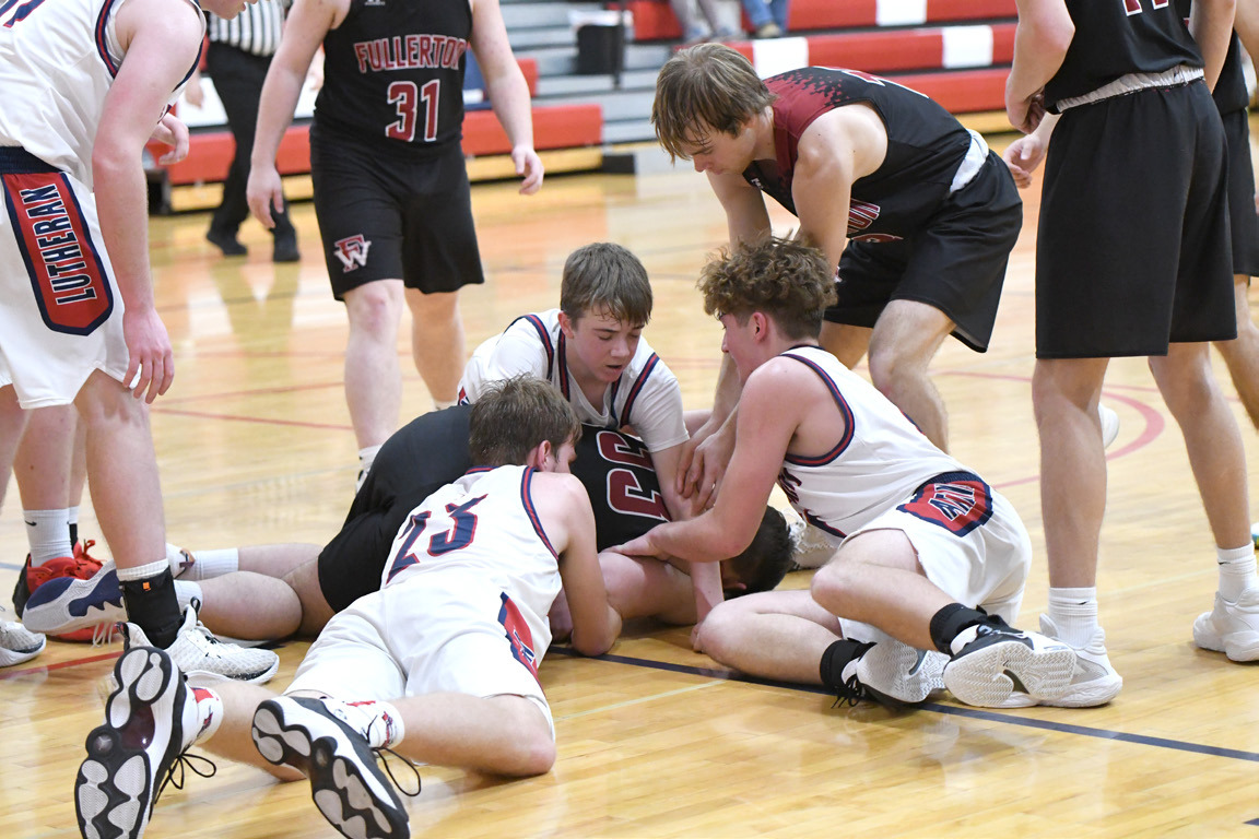 Kenton Dudek dives for a loose ball during the second half of Saturday’s game. NCJ photo by Calvin Holtz