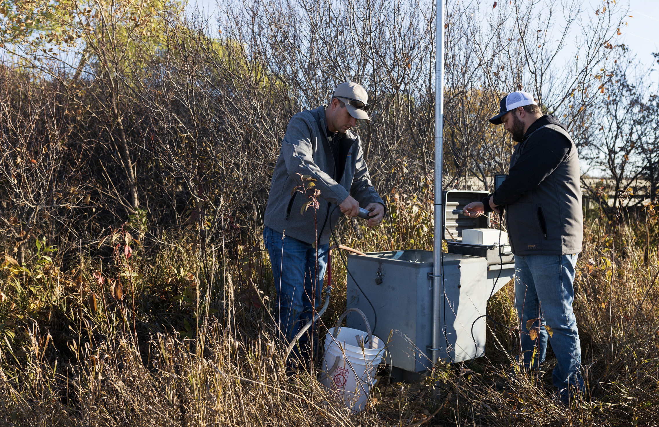Water resources technicians Josh Schnitzler and Connor Baldwin, who both work for the Lower Elkhorn Resources District in Norfolk, prepare to test the water in a monitoring well near the north fork of the Elkhorn River in 2022. A recent stateled effort to test private wells in Nebraska found 15% had nitrate levels above what the Environmental Protection Agency considers safe. Photos by Ryan Soderlin for the Flatwater Free Press