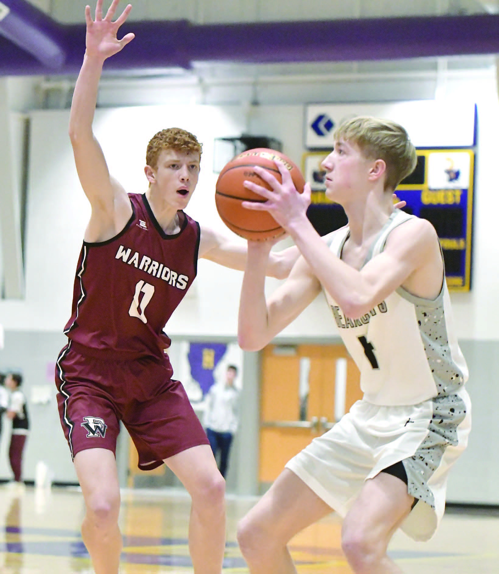Jacob Maxfield plays tight defense during the first quarter of Fullerton's game against Hampton/Heartland.