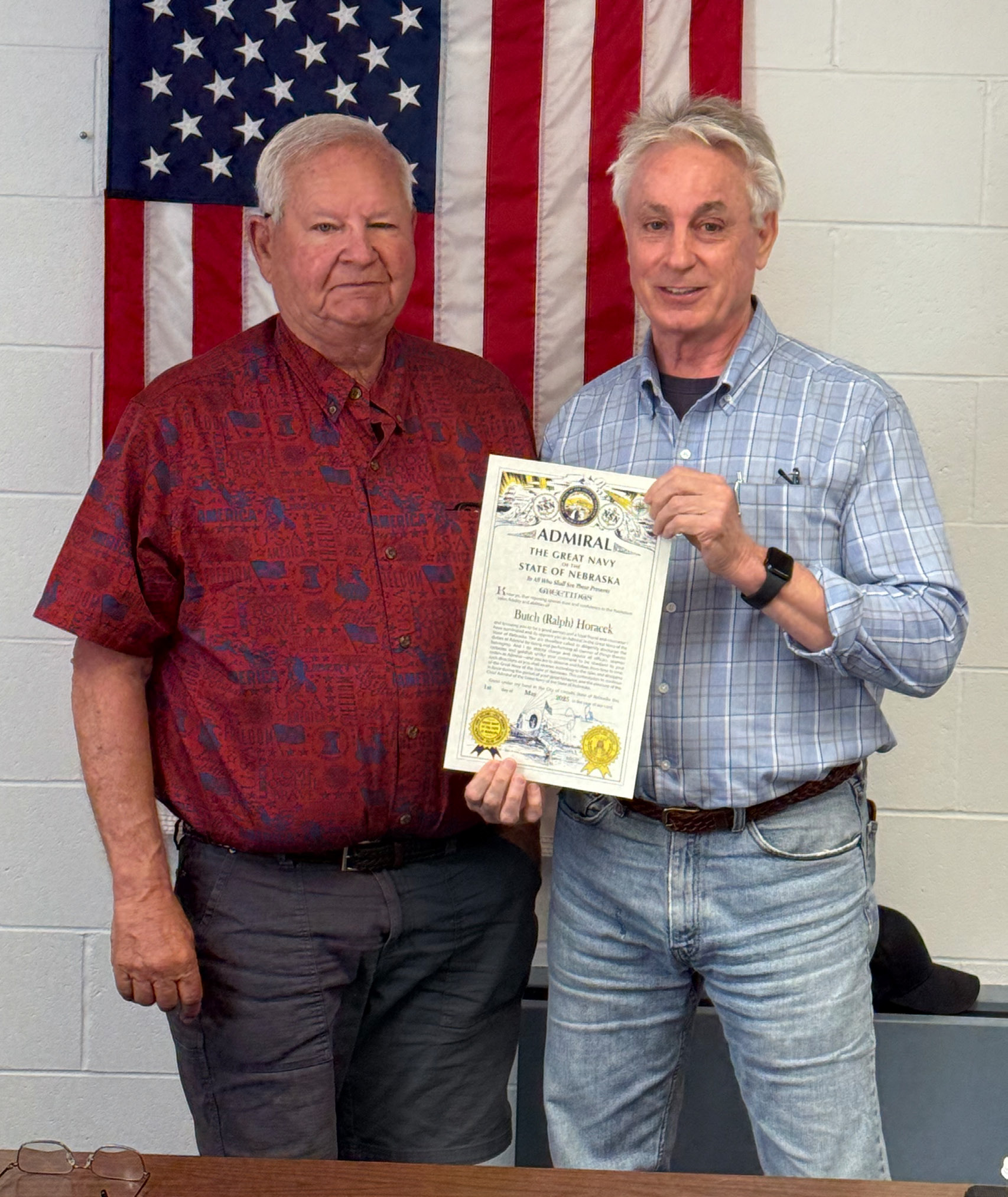Butch Horacek (left) was surprised Tuesday morning with an announcement that he was being named a Nebraska Admiral. State Senator Loren Lippincott presented the honor during the Nance County Board of Supervisors meeting. NCJ photo by Rick Holtz