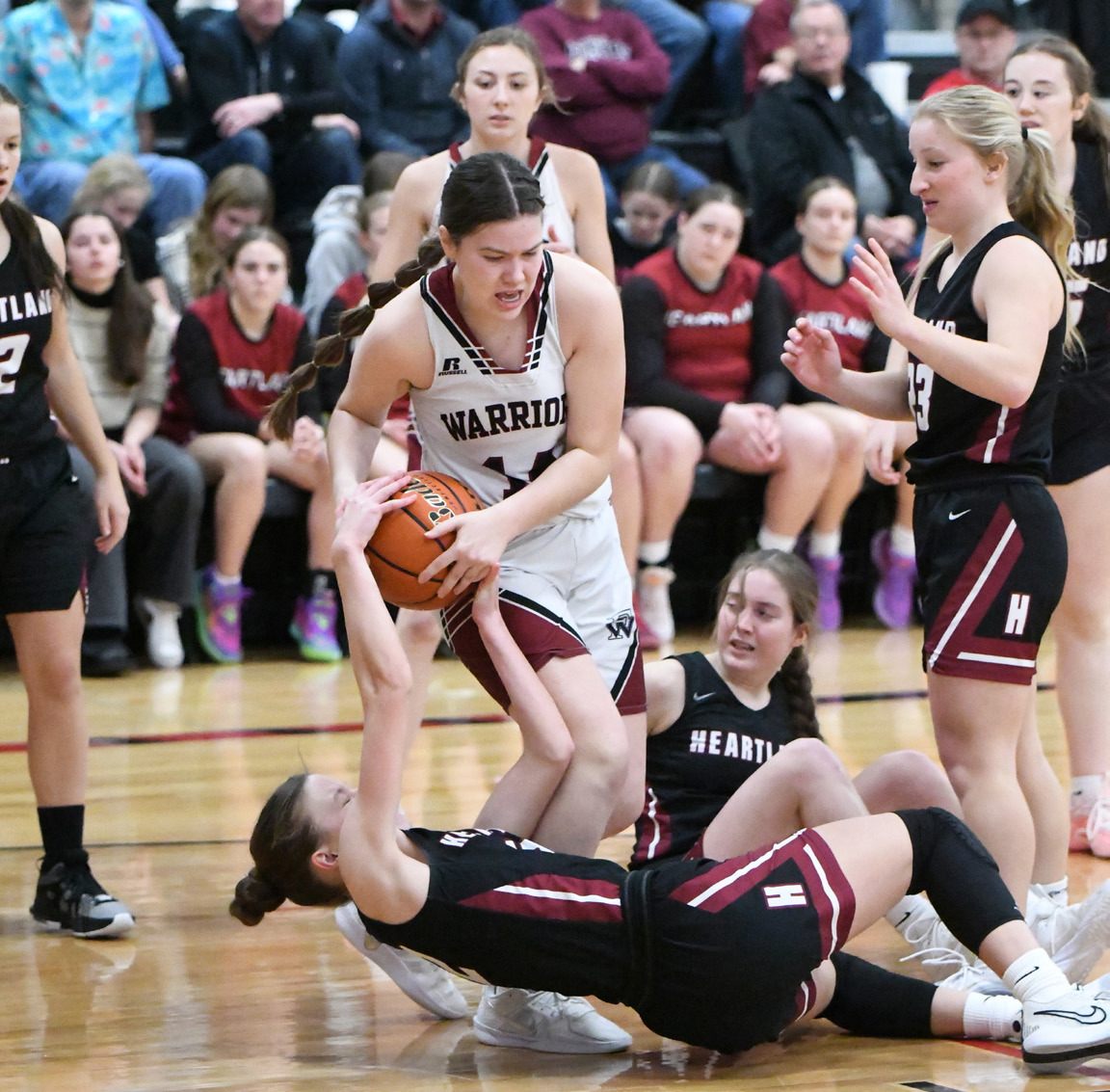 Georgia Bridger fights for a loose ball on Friday against Heartland. NCJ photo by Rick Holtz