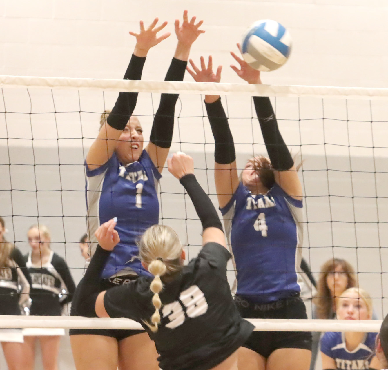 Tricia Kunkee and Jaclyn Everett go up for a block at the net against Hampton-Heartland. NCJ photo by Ken Kush