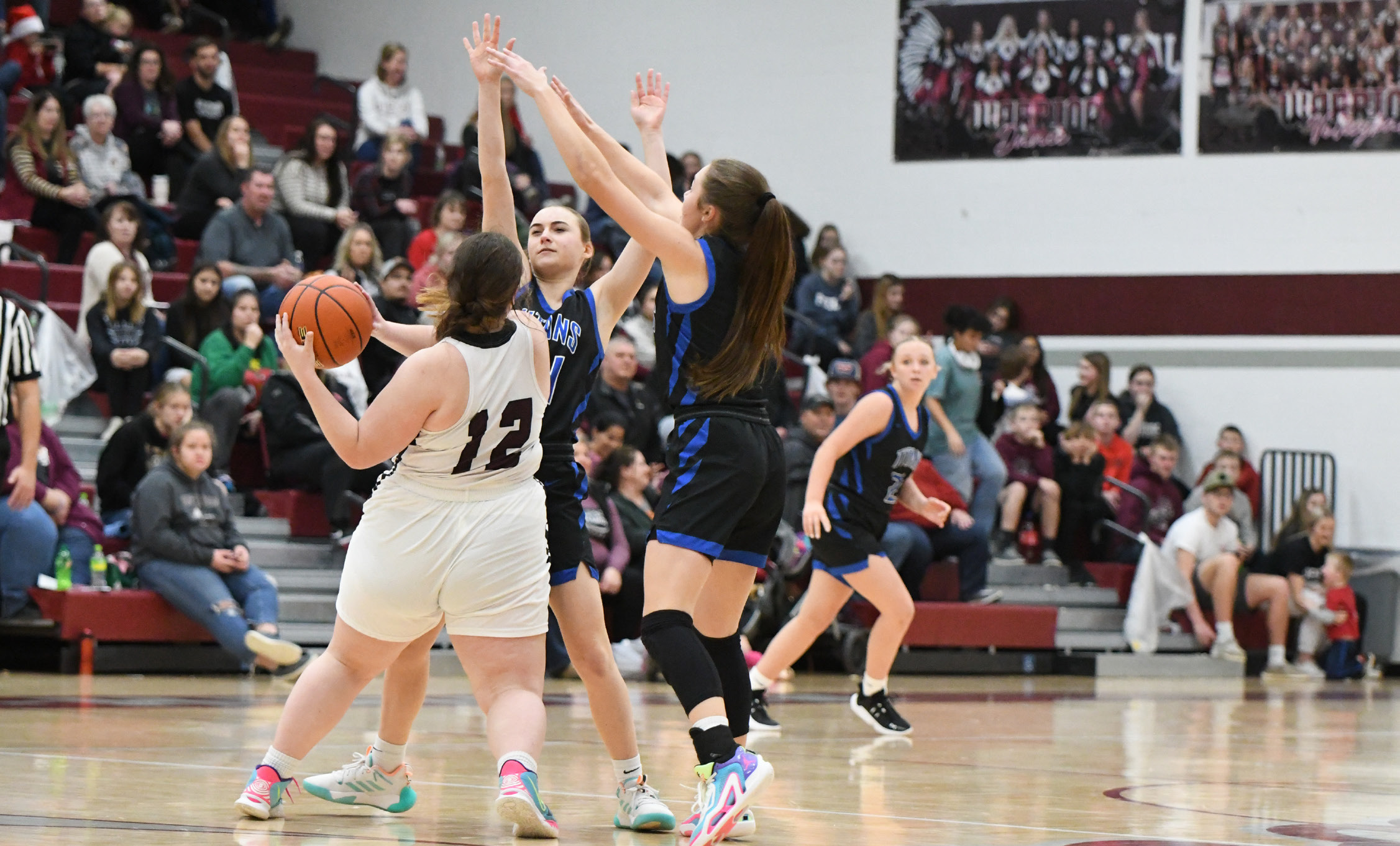 Katie Preister and JLee Van Driel play smothering defense in the second half last Tuesday. The Titan defense stepped up and forced multiple turnovers as they rallied from a 16 point halftime deficit. NCJ photos by Rick Holtz