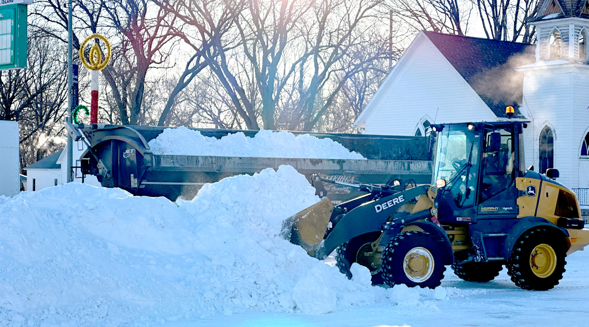 Crews worked Tuesday morning to remove piles of snow from Broadway in Fullerton. Nance County was hit with a second round of snow last week that closed schools on Friday and Monday. NCJ photos by Rick Holtz