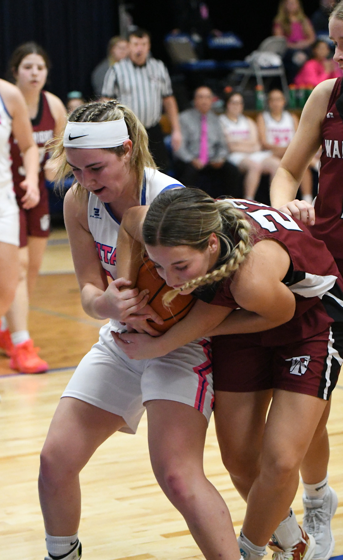 County bragging rights were up for grabs on Friday in Genoa. Delaney Reeg and Isabel Norman both grab possession of a rebound. NCJ photos by Rick Holtz