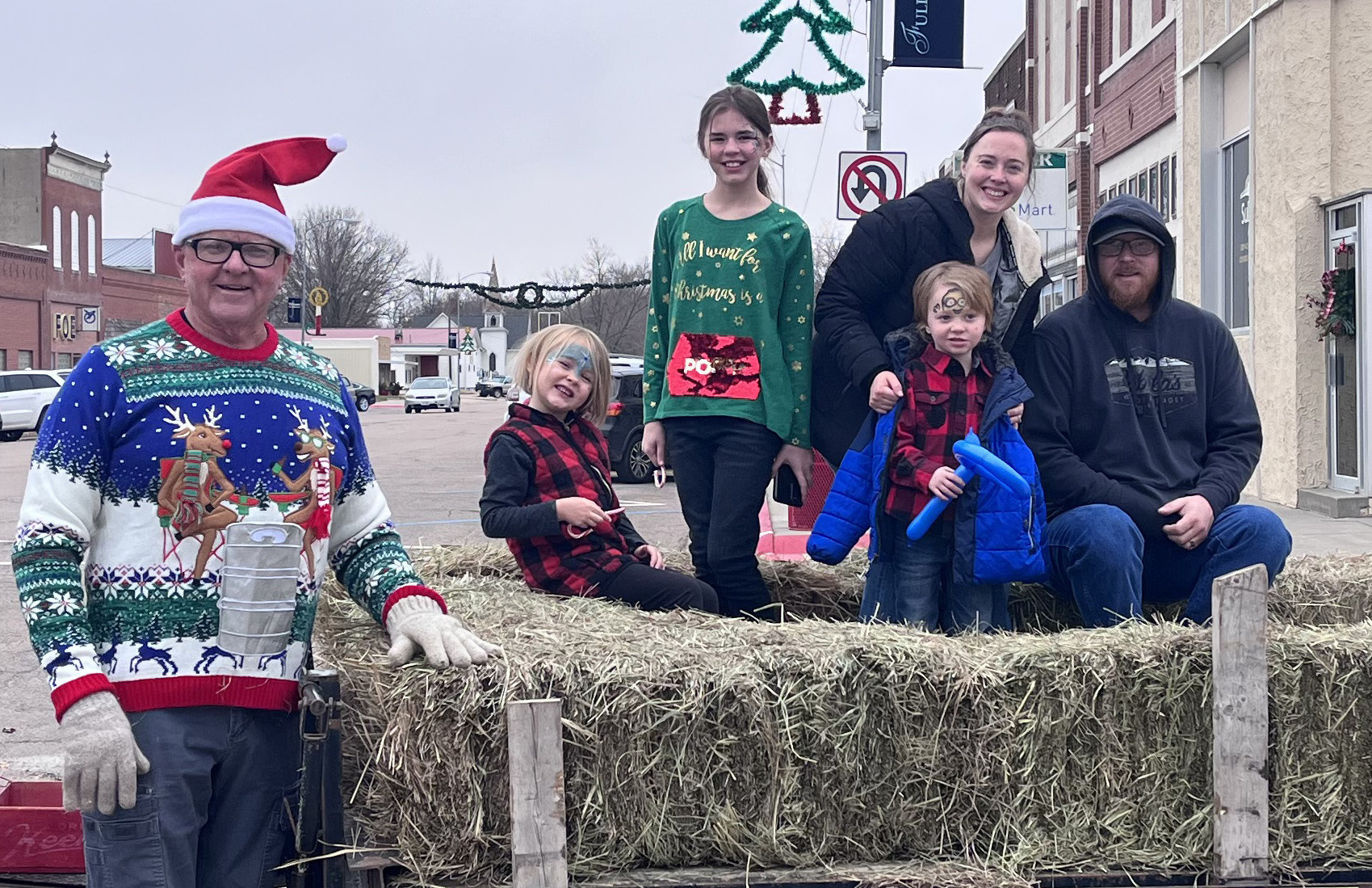 Dallas Schweitz prepares to drive the hayrack rides with the Hodgman family (Nate, Jaylie, Sarah, Paisley, Lincoln) in tow.