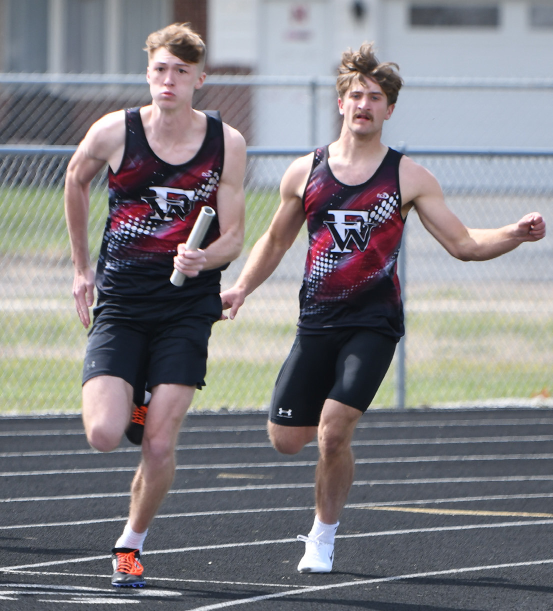 Kane Wetovick takes the baton from Fletcher Dubas is the 4x100-meter relay. NCJ photos by Rick Holtz
