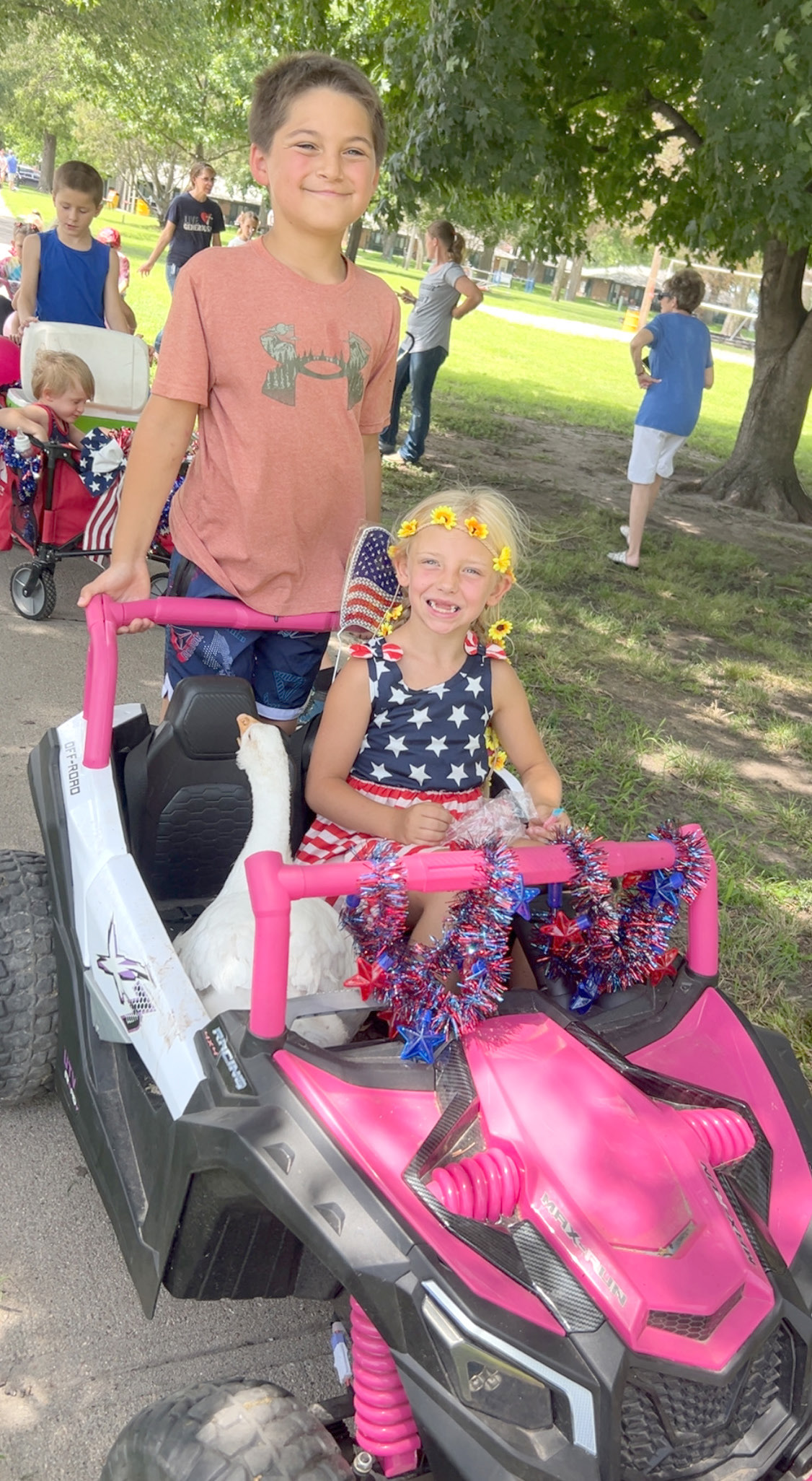 Aubrey Collins, 8, gives her goose Nibbles a ride during the Fourth of July sidewalk parade. Joining her on the ride was her cousin, Maverick Creutzberg. Photo provided