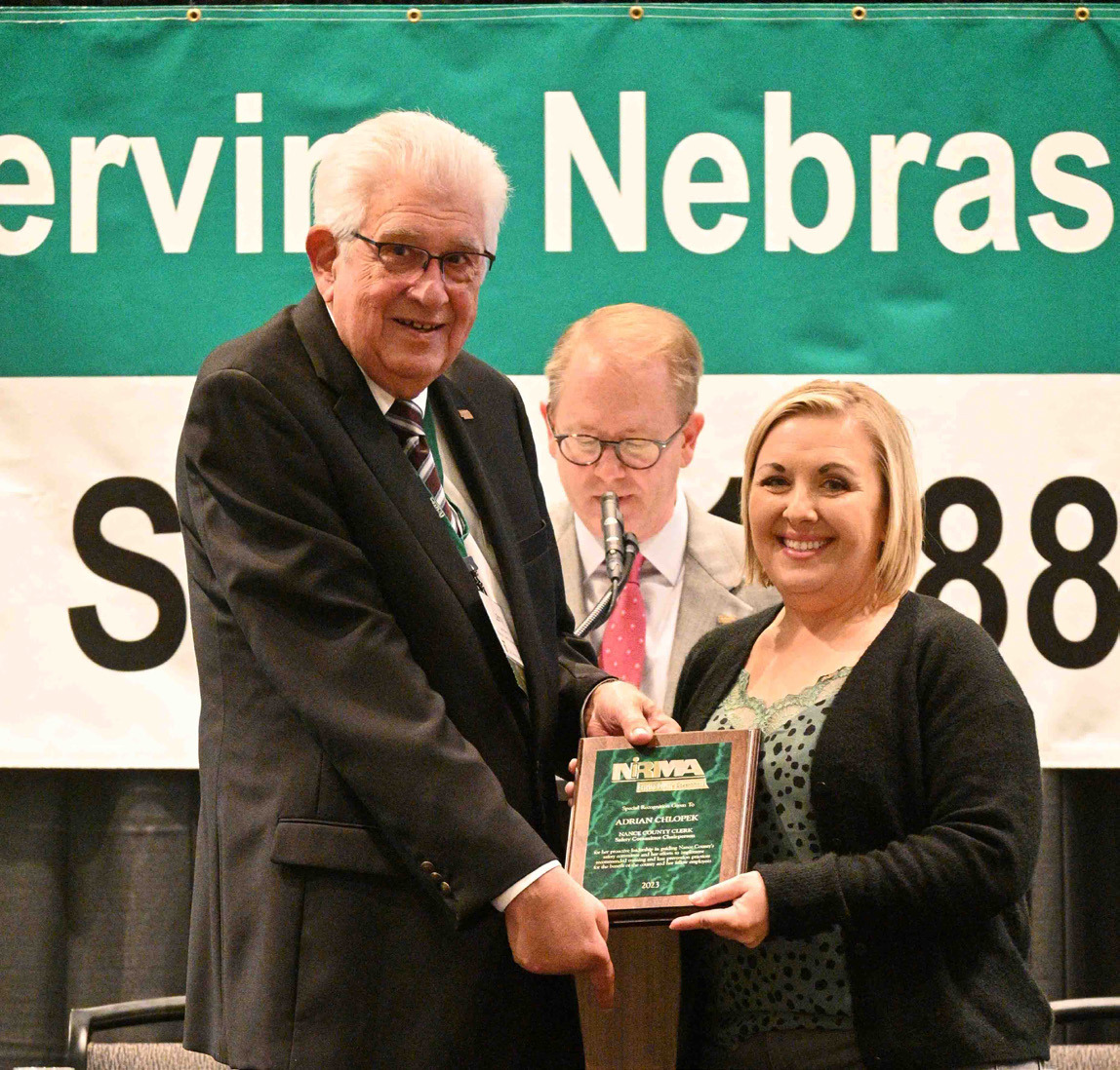 Nance County Clerk and safety committee chairperson Adrian Chlopek is shown accepting a Special Recognition Award from NIRMA Board of Directors Chair Larry Cerny. Photo provided