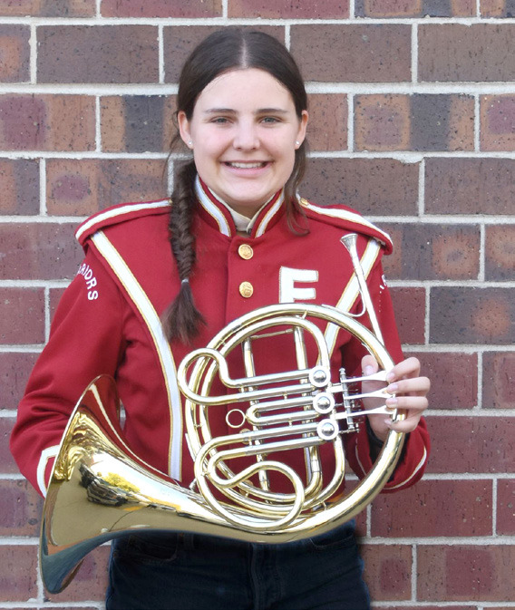Lylla Sabata stands with her french horn. Photo by Laura Sabata