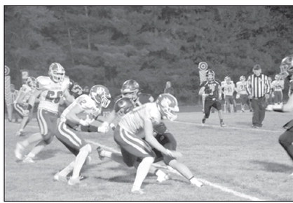 Aiden Norman (2) follows a legion of blockers on his way to a touchdown Friday night. Photo courtesy of Beth Sparrow