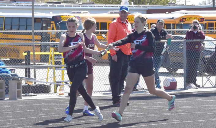 Josie Williams takes the baton from Paige Horn in the 4x400-meter relay. NCJ photos by Cienna Friesen