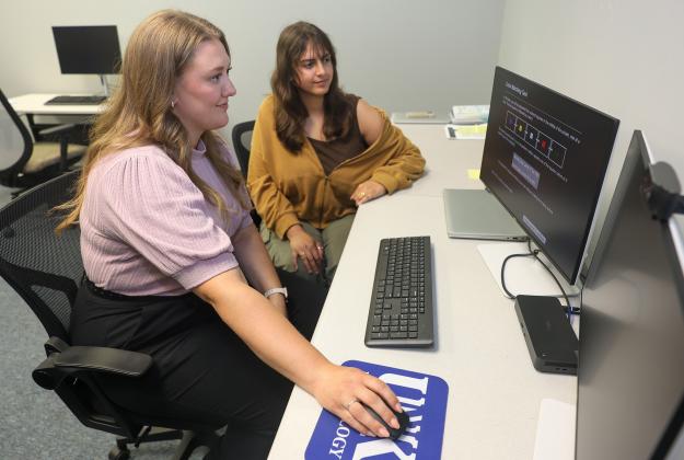 Assistant psychology professor Rachael Turner, front, and UNK senior Blaine Tewahade are studying the cognitive challenges faced by caregivers and support systems that may help reduce those impacts. Photo by Erika Pritchard, UNK Communications