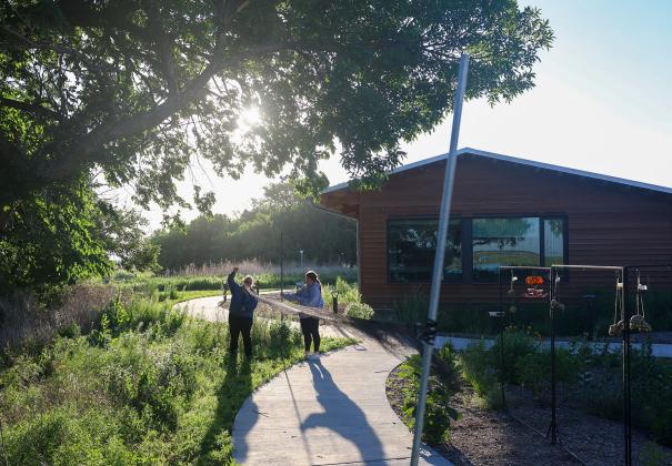 UNK biology professor Letty Reichart and senior Morgan Holm set up a net at Rowe Sanctuary to capture birds for their research project. Photo by Erika Pritchard, UNK Communications