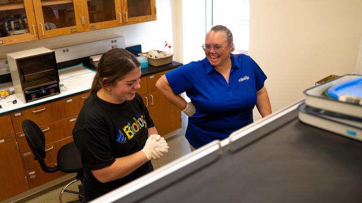 UNK senior Morgan Holm, left, and biology professor Letty Reichart chat while testing blood samples inside a lab at Bruner Hall. Photo by Kollin Goff, UNK Communications
