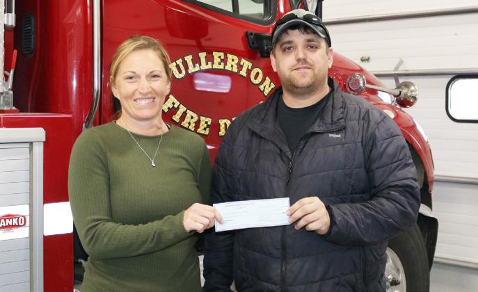 Cornhusker Public Power District Goodwill Fund Trustee Abie Czapla (left) presents $500 to Fullerton Volunteer Fire Department for wildland tools. Accepting the check is President Dillon Busch (right).