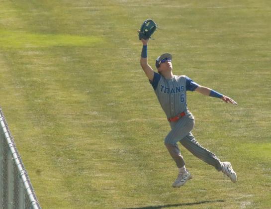 Braxtin Fowler tracks a deep fly ball as he approaches the center field fence on Thursday in Twin River’s district game against Lincoln Christian. NCJ photo by Ken Kush