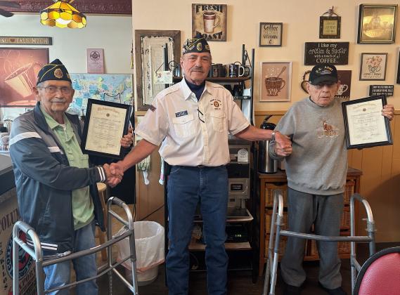 Denny Backman (left) and Bob Patrick were presented with framed certificates recognizing them for 50 years of continuous membership to the American Legion. Genoa Post Commander John Buhl presented the men with the honors on Thursday at Fill My Cup in Genoa. NCJ photo by Rick Holtz