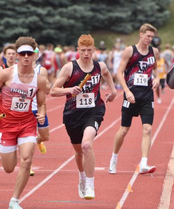 Jacob Maxfield takes off after receiving the baton from Kane Wetovick in the 4x800-meter relay. Both also ran legs on the 4x400-meter relay team. NCJ photo by Beth Sparrow