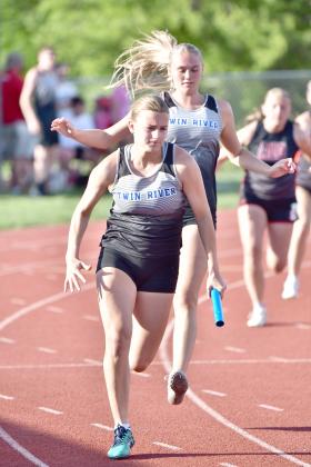 RIGHT: Callie Held takes the baton from Grace Yrkoski to run the final leg of the Titans’ 4x100meter relay. NCJ photos by Rick Holtz