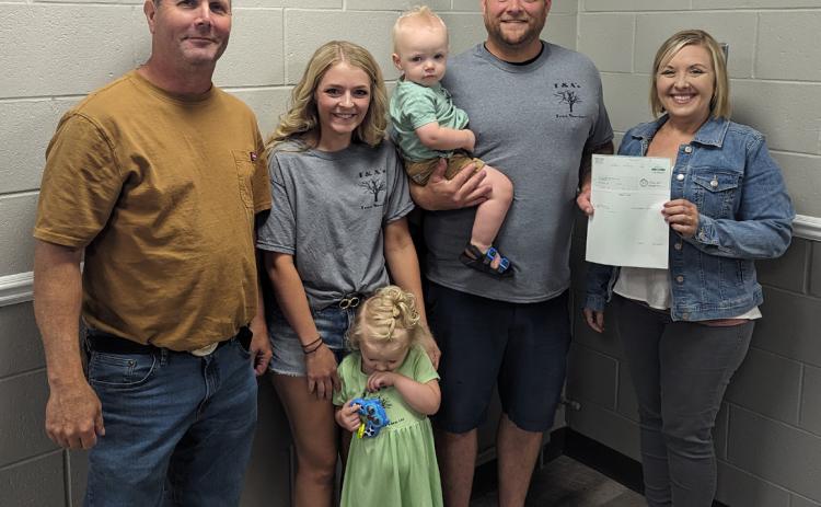 Pictured are Tim Cornwell (Board of Supervisors Chairperson), Abigail Bishop and Tony Steensnes and their children Harper and Maverick (Owners of T & A’s Tree Service, LLC) and Adrian Chlopek (NCDA Director).