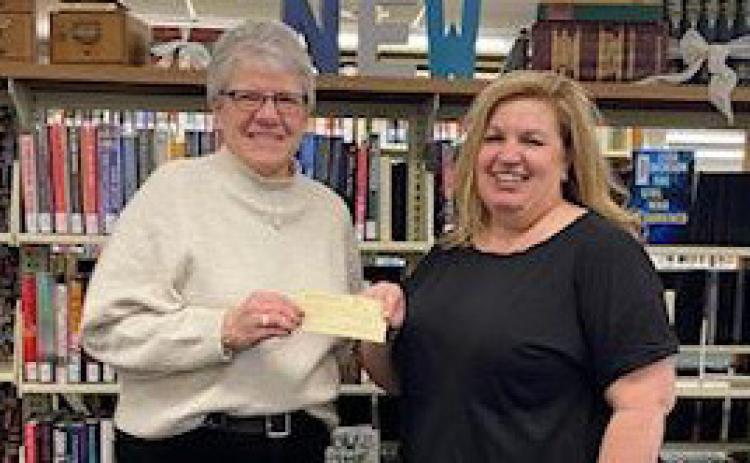 LISA LASSEK board member of the Nance County Foundation, presented a check for $1,500.00 to Laurel Marlatt, Library Director of the Fullerton Public Library for assistance in current renovations at the Fullerton Public Library. The support will help defray the costs of safely and efficiently moving the books and shelving so the new carpet can be installed.