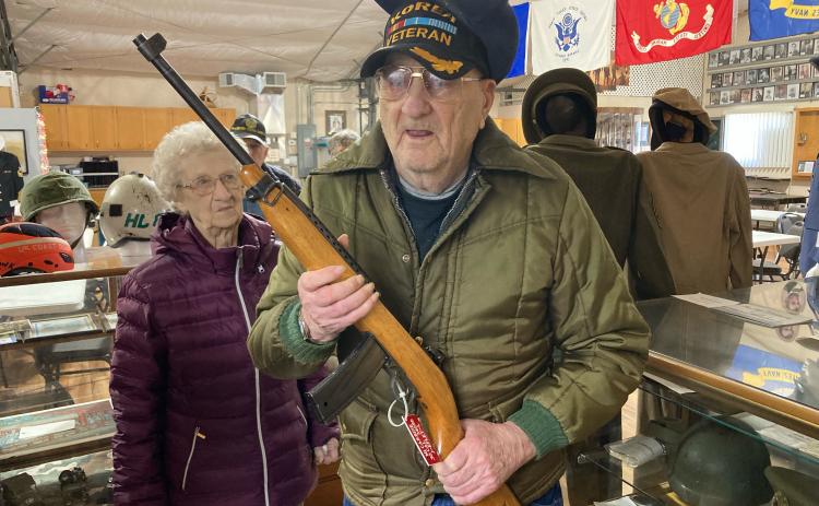Mel McCray is holding the gun that he used during his time in the service. Courtesy photos