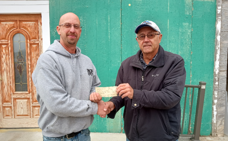 David Tejral, president of the Nance County Foundation, presents the grant to Bob Green, director and coach of the Twin River Youth Football Program. Photo provided